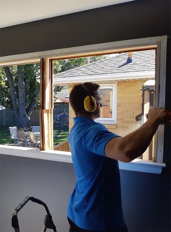 Window technician replacing a window in Windsor-Essex.